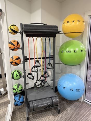 Large well-equipped fitness center with yoga area and free weights open 24 hours